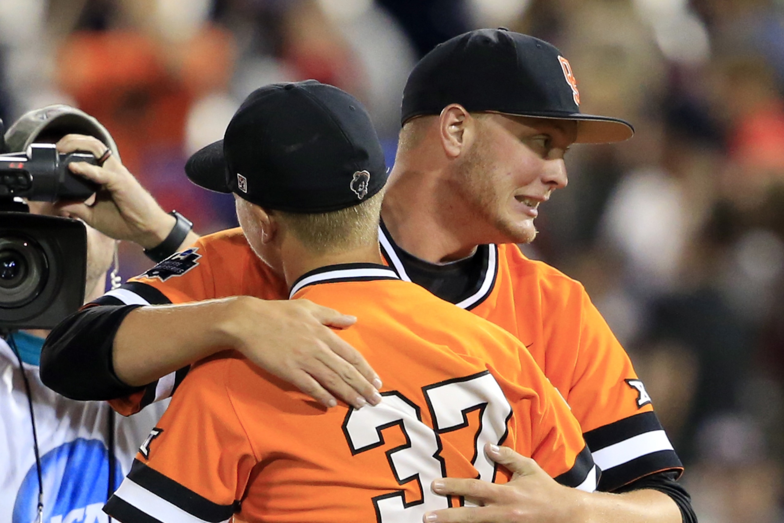 Oklahoma State's Tyler Buffett (37) and teammate Ryan Sluder celebrate following a 1-0 victory over Arizona during an NCAA College World Series baseball game, Monday, June 20, 2016, in Omaha, Neb. (AP Photo/Nati Harnik) Oklahoma State's Tyler Buffett (37) and teammate Ryan Sluder celebrate following a 1-0 victory over Arizona during an NCAA College World Series baseball game, Monday, June 20, 2016, in Omaha, Neb. (AP Photo/Nati Harnik)