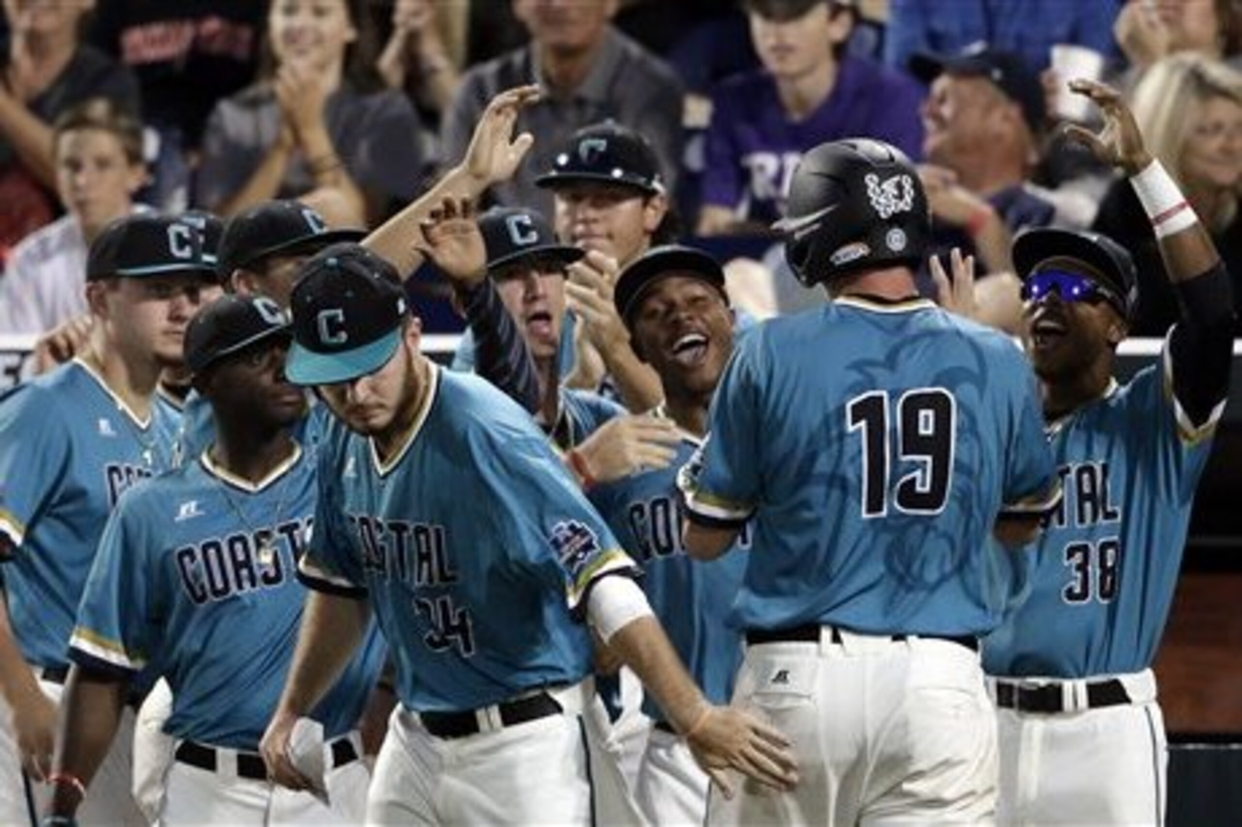 Coastal Carolina's Kevin Woodall Jr. (19) celebrates after scoring on a David Parrett two-run single in the fifth inning of an NCAA College World Series baseball game in Omaha, Neb., Thursday, June 23, 2016. (AP Photo/Nati Harnik)