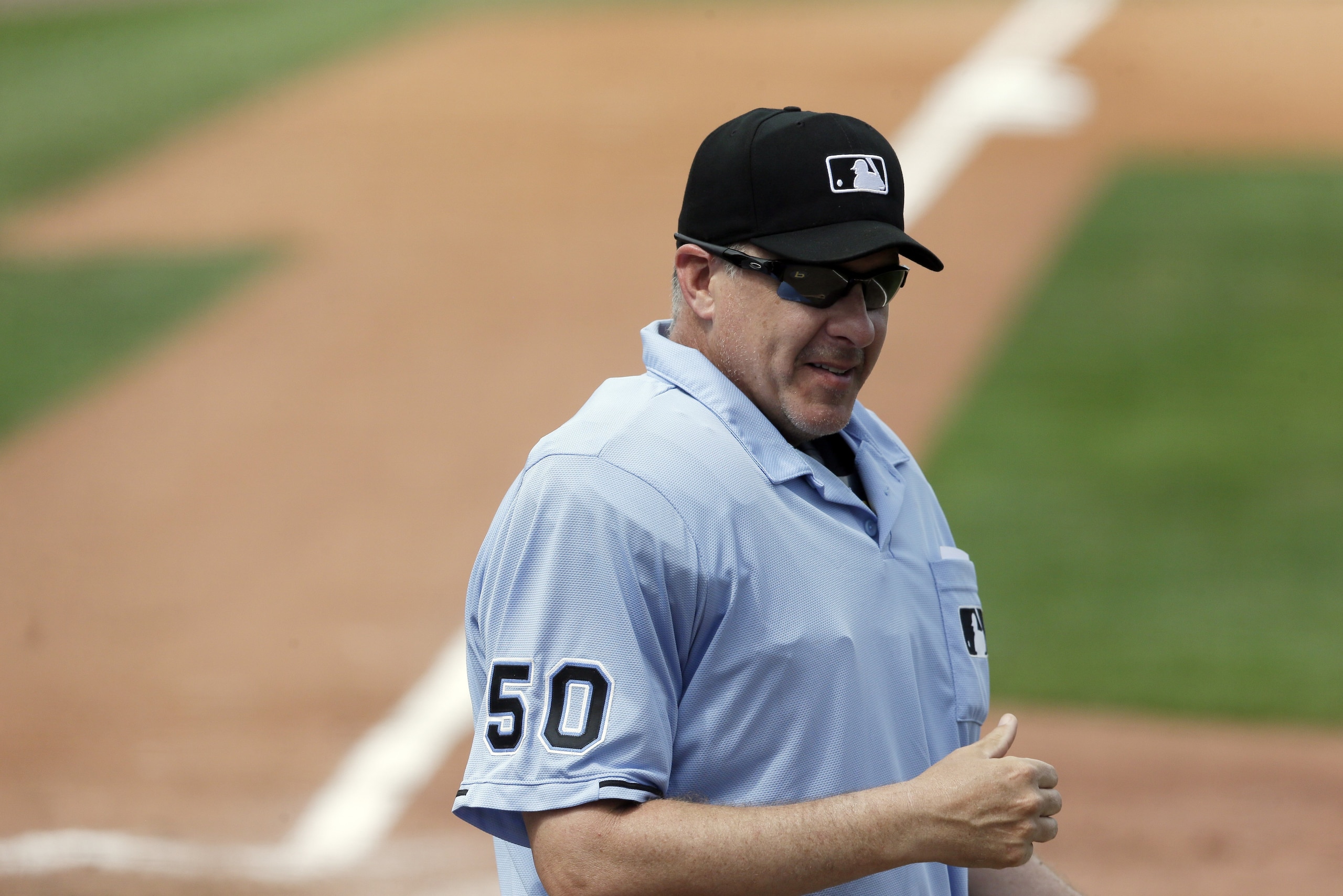 Umpire Paul Emmel is seen during the seventh inning of a spring training exhibition baseball game between the Pittsburgh Pirates and the Atlanta Braves in Bradenton, Fla., Thursday, March 26, 2015. (AP Photo/Carlos Osorio)