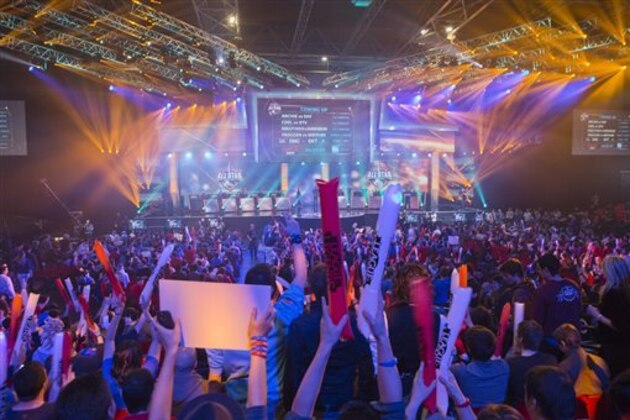 FILE - In this May 11, 2014 file photo, fans watch the opening ceremony of the League of Legends season 4 World Championship Final between South Korea against China's Royal Club, in Paris. With millions of gamers now regularly spectating video games online and in arenas, game developers are angling to learn a few lessons from esports and possibly create the next