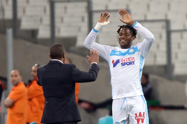 Marseille's Belgian forward Michy Batshuayi, right, celebrates with Marseille's coach Franck Passi,  after scoring against Reims, during the League One soccer match between Marseille and Reims, at the Velodrome Stadium, in Marseille, southern France, Saturday, May 7, 2016. (AP Photo/Claude Paris)