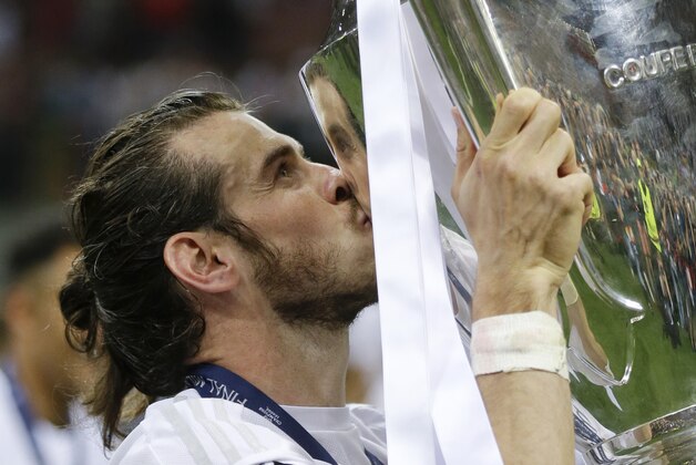 Real Madrid's Gareth Bale kisses the trophy after the Champions League final soccer match between Real Madrid and Atletico Madrid at the San Siro stadium in Milan, Italy, Saturday, May 28, 2016. Real Madrid won 5-3 on penalties after the match ended 1-1 after extra time.  (AP Photo/Andrew Medichini)