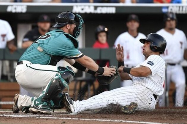 Coastal Carolina catcher David Parrett tags Texas Tech's Eric Gutierrez out at home in the second inning of an NCAA College World Series baseball game in Omaha, Neb., Thursday, June 23, 2016. (AP Photo/Ted Kirk)
