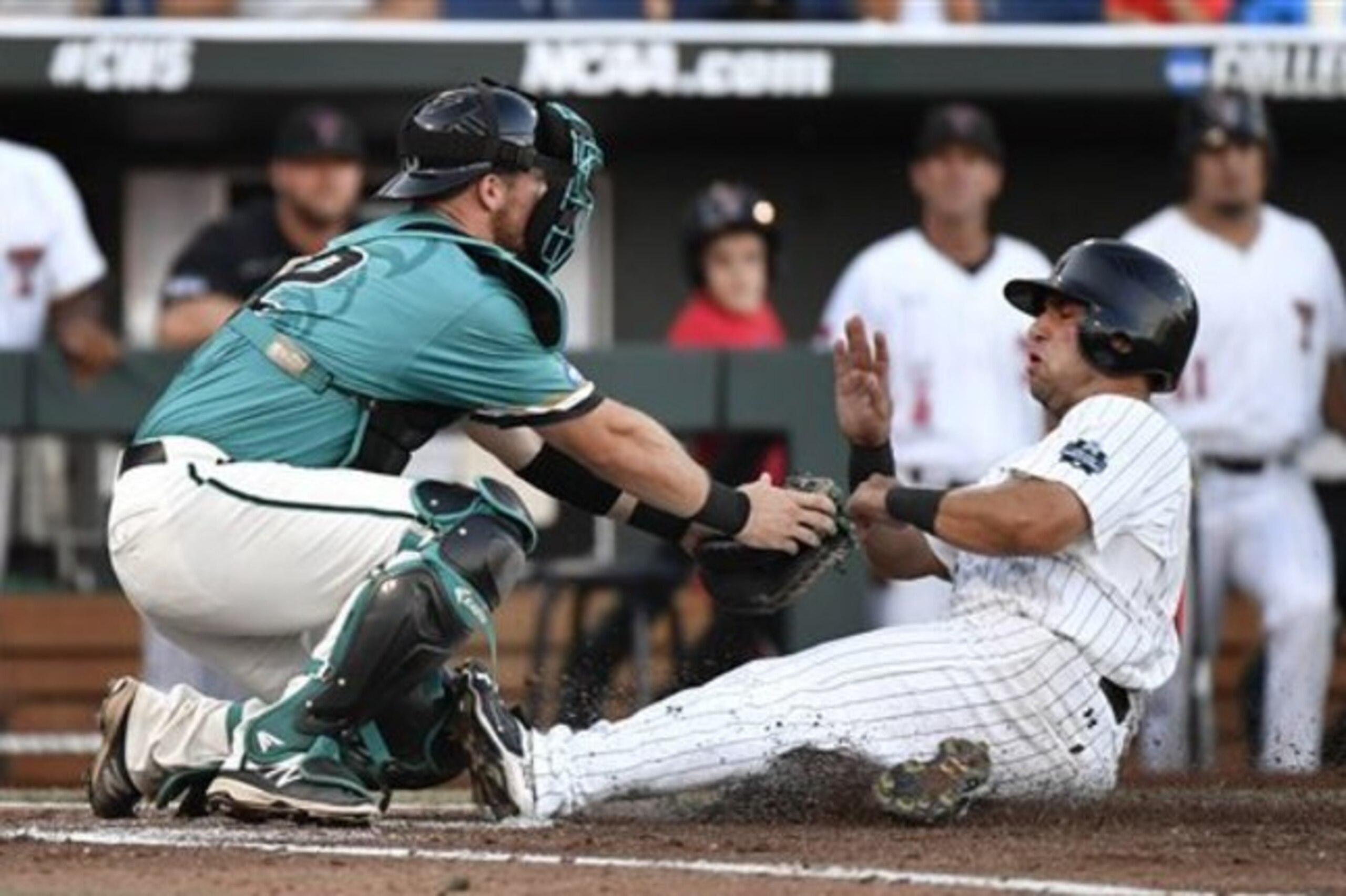 Coastal Carolina catcher David Parrett tags Texas Tech's Eric Gutierrez out at home in the second inning of an NCAA College World Series baseball game in Omaha, Neb., Thursday, June 23, 2016. (AP Photo/Ted Kirk)
