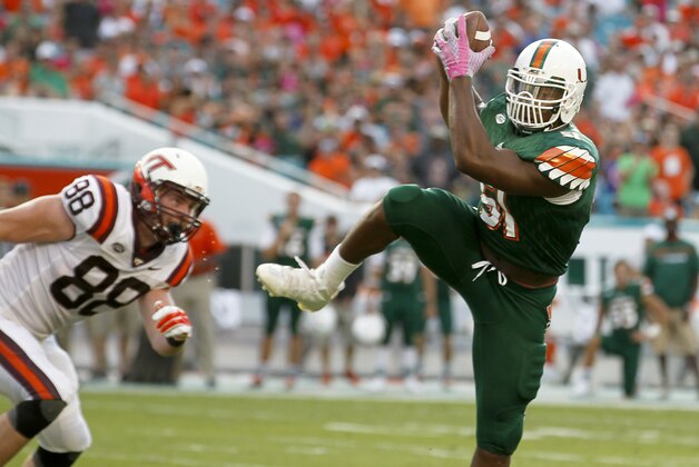 Miami linebacker Juwon Young (51) intercepts a second half pass as Virginia Tech tight end Ryan Malleck (88) pursues in an NCAA college football game, Saturday, Oct. 17, 2015, in Miami Gardens, Fla. Miami won the game 30-20. (AP Photo/Joe Skipper)