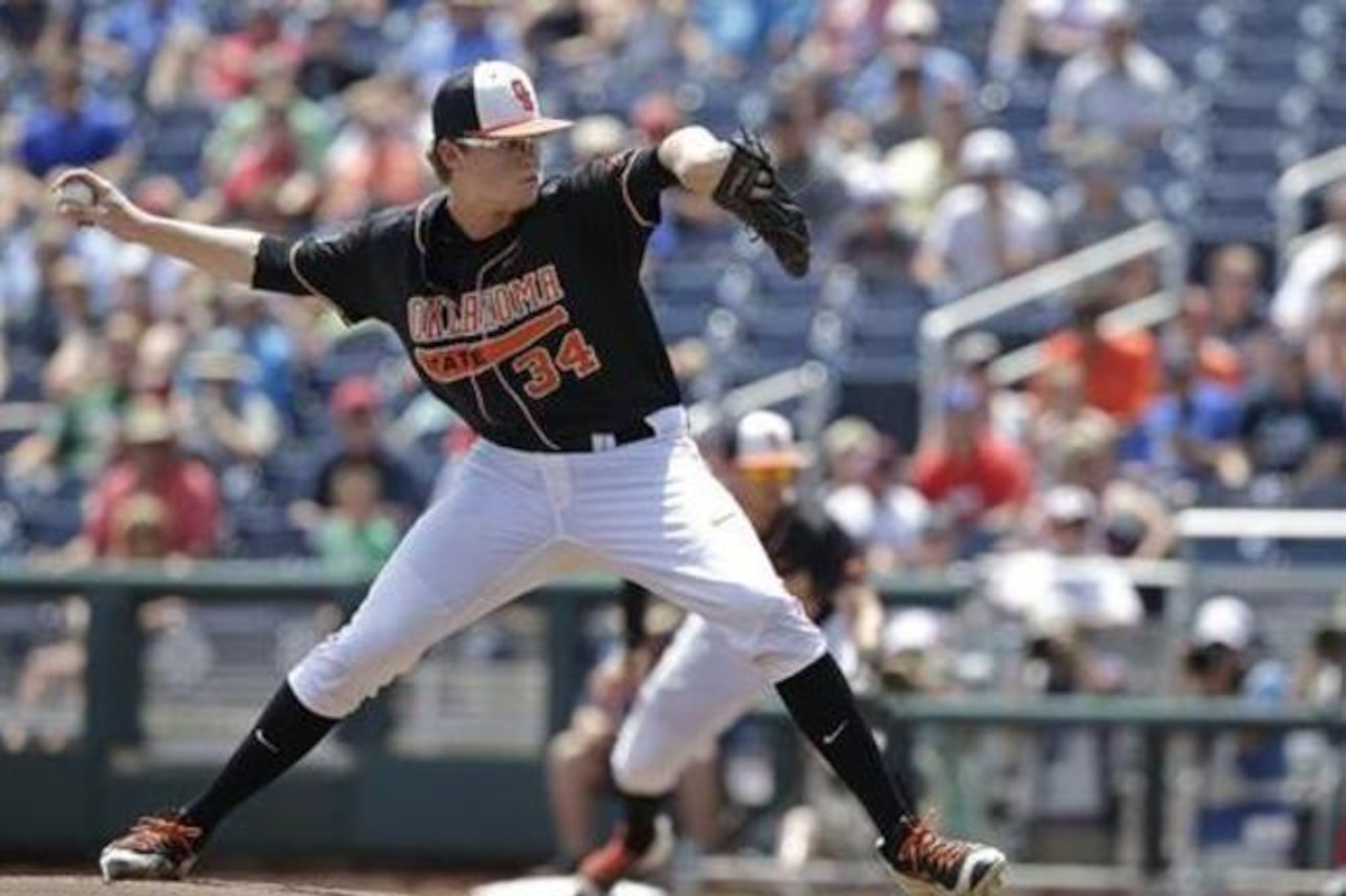 Oklahoma State's Jensen Elliott (34) pitches against Arizona in the first inning of an NCAA men's College World Series baseball game, Friday, June 24, 2016, in Omaha, Neb. (AP Photo/Nati Harnik)