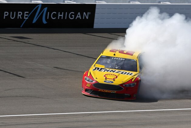 Jun 12, 2016; Brooklyn, MI, USA; Sprint Cup Series driver Joey Logano (22) celebrates winning the FireKeepers Casino 400 at Michigan International Speedway. Mandatory Credit: Aaron Doster-USA TODAY Sports