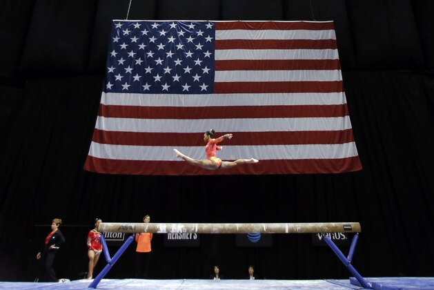 Gabby Douglas warms up for a routine on the balance beam during the U.S. women's gymnastics championships, Friday, June 24, 2016, in St. Louis. (AP Photo/Tony Gutierrez)
