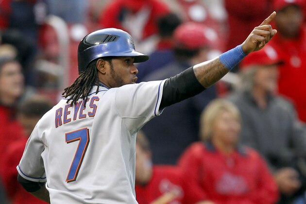 New York Mets' Jose Reyes points to teammate Willie Harris after Reyes scored on a two-run single by Harris during the ninth inning of a baseball game Thursday, Sept. 22, 2011, in St. Louis. The Mets won 8-6. (AP Photo/Jeff Roberson)