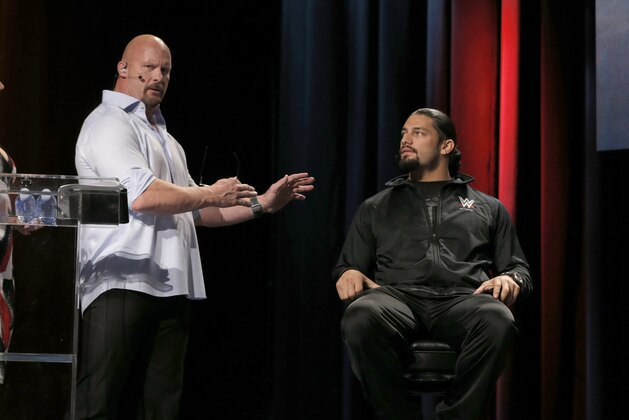 WWE Hall of Famer Stone Cold Steve Austin and WWE Superstar Roman Reigns attend the SummerSlam Confidential Panel at Club Nokia, on Saturday, August 16, 2014 in Los Angeles. (Photo by Todd Williamson/Invision for 2K/AP Images)