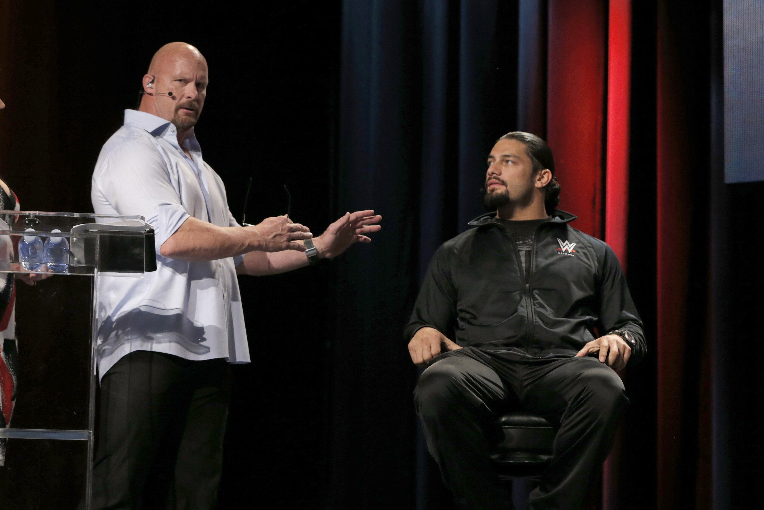 WWE Hall of Famer Stone Cold Steve Austin and WWE Superstar Roman Reigns attend the SummerSlam Confidential Panel at Club Nokia, on Saturday, August 16, 2014 in Los Angeles. (Photo by Todd Williamson/Invision for 2K/AP Images)
