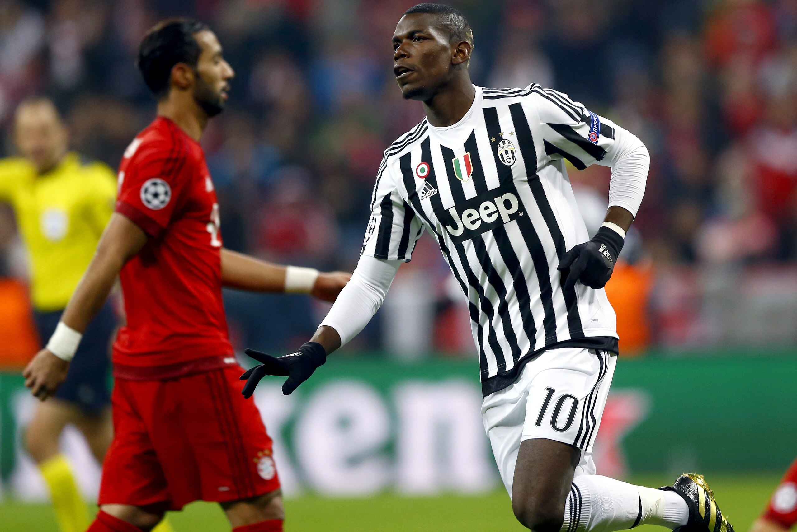 Juventus' Paul Pogba, right, celebrates after scoring the opening goal during the Champions League round of 16 second leg soccer match between FC Bayern Munich and Juventus Turin in Munich, southern Germany, Wednesday, March 16, 2016. (AP Photo/Matthias Schrader)