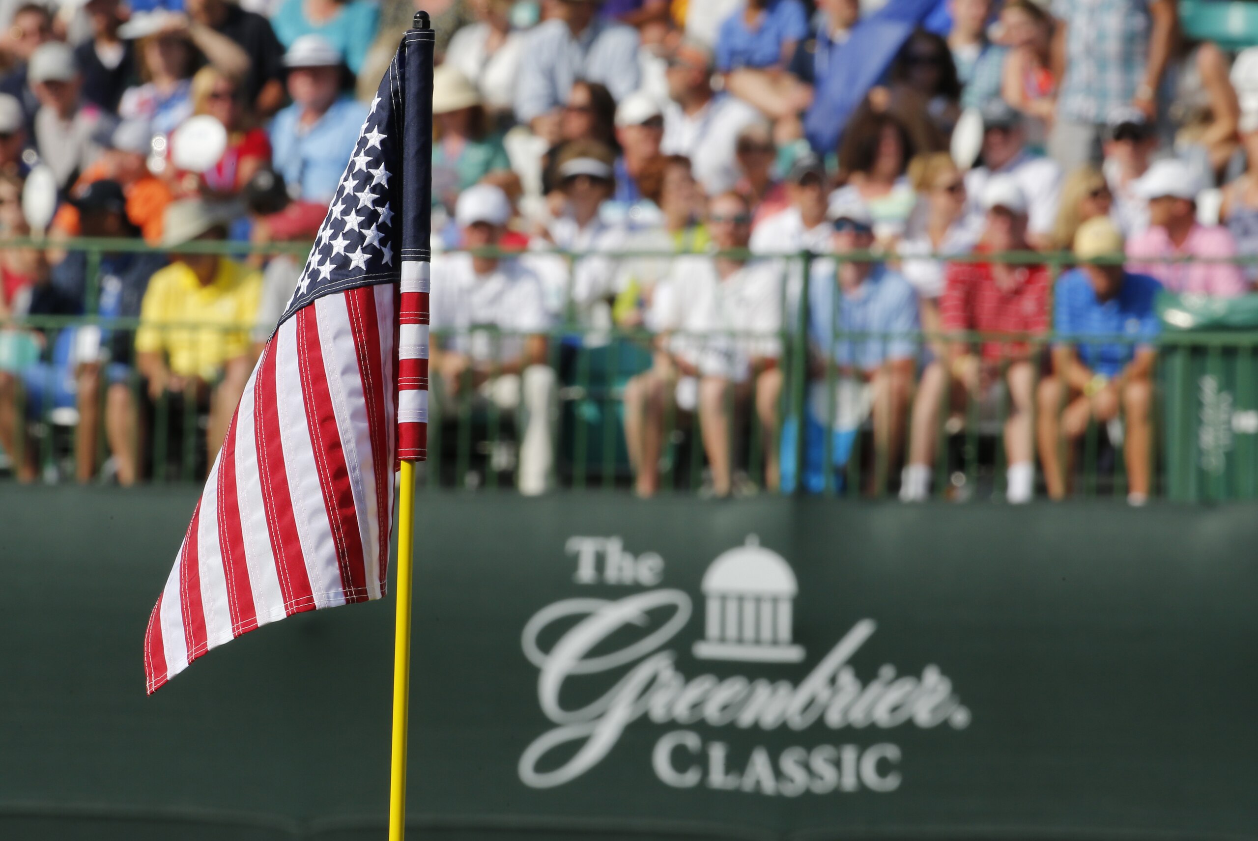 The flag on the 18th hole is replaced by a United States flag during the third round of the Greenbrier Classic golf tournament at Greenbrier Resort in White Sulphur Springs, W.Va., Saturday, July 4, 2015.  (AP Photo/Steve Helber)