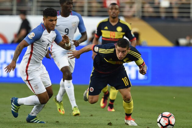 Colombia's James Rodriguez (R) stumbles next to USA's DeAndre Yedlin during the Copa America Centenario football tournament in Santa Clara, California, United States, on June 3, 2016. / AFP / MARK RALSTON        (Photo credit should read MARK RALSTON/AFP/Getty Images)