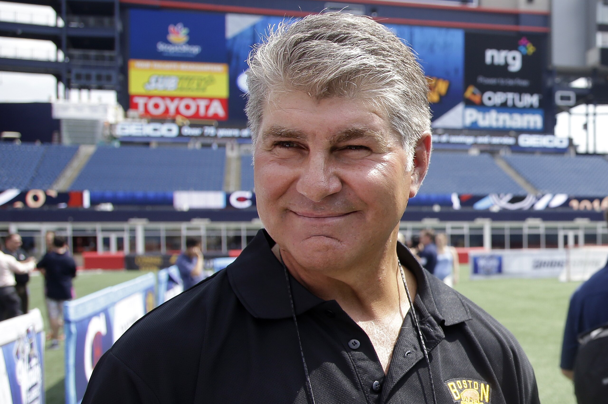 Former Boston Bruins star Ray Bourque walks on the field during an event at Gillette Stadium Wednesday, July 29, 2015, in Foxborough, Mass., to promote the NHL Winter Classic hockey game between the Bruins and Montreal Canadiens, scheduled to be played there on New Year's day 2016.  (AP Photo/Stephan Savoia)