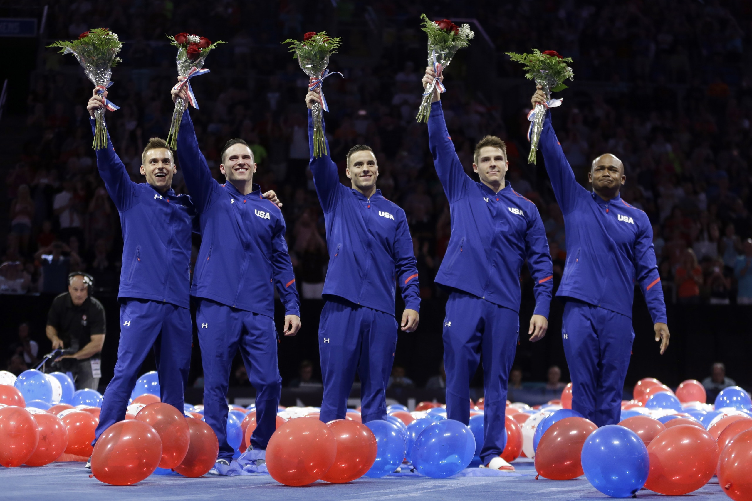 From left to right, Sam Mikulak, Alex Naddour, Jake Dalton, Chris Brooks and John Orozco wave to the crowd after being named to the U.S. men's Olympic gymnastics team Saturday, June 25, 2016, in St. Louis. (AP Photo/Jeff Roberson)
