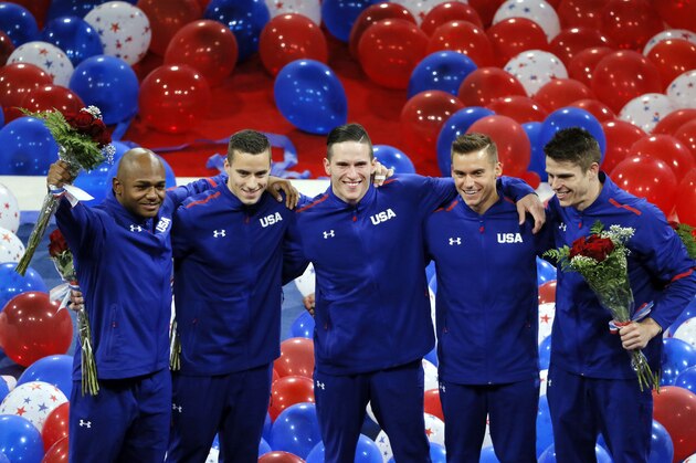 Sam Mikulak, from left, Alex Naddour, Chris Brooks, Jacob Dalton and John Orozco, right, acknowledge cheers from fans after being introduced as the U.S. men's Olympic gymnastics team, Saturday, June 25, 2016, in St. Louis. (AP Photo/Tony Gutierrez)