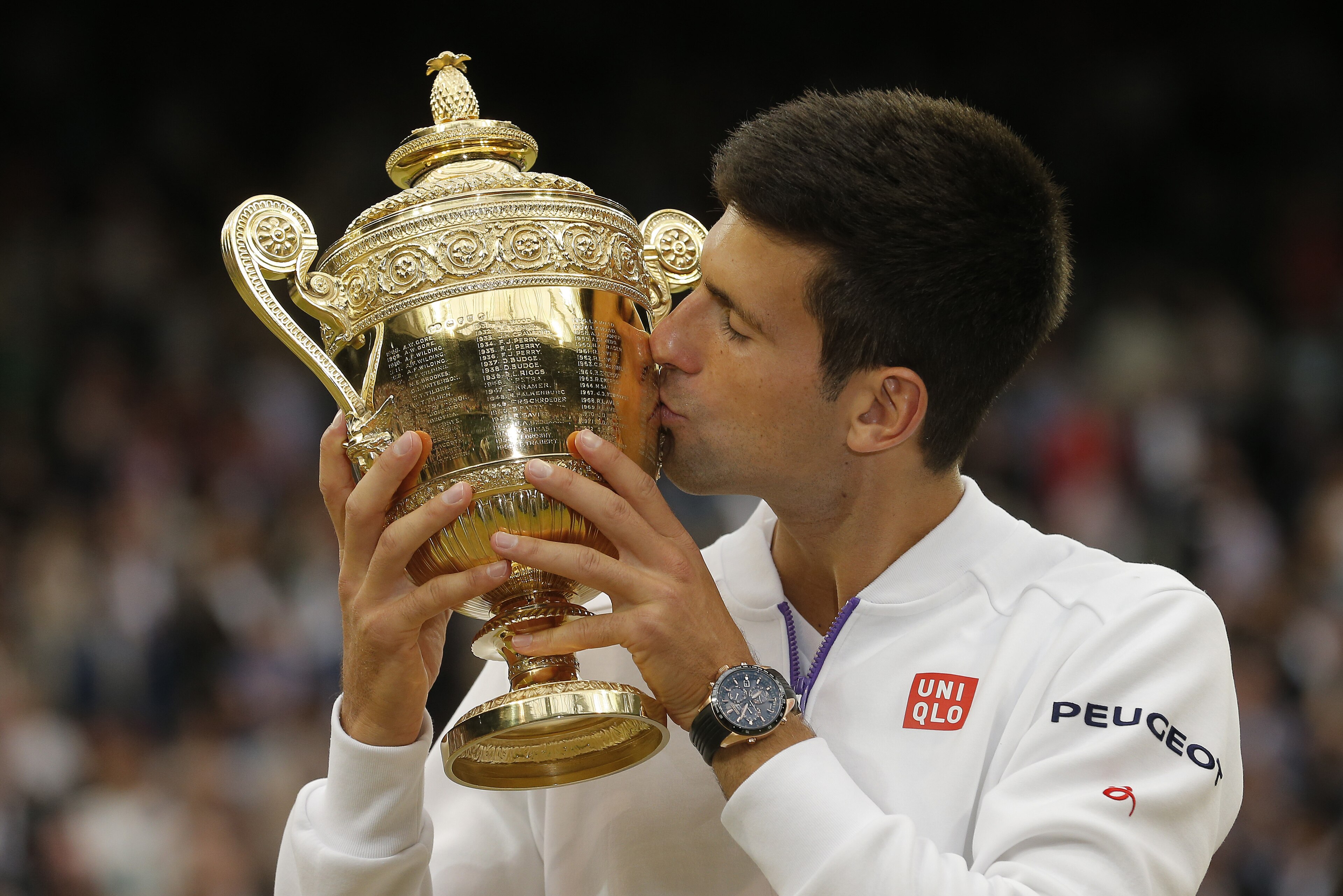 Novak Djokovic kisses the trophy after his victory over Roger Federer in the mens singles final on Centre Court during day thirteen of Wimbledon 2015 at the All England Lawn Tennis Club on July 12th 2015 in Wimbledon (Photo by Tom Jenkins/Getty Images) Novak Djokovic kisses the trophy after his victory over Roger Federer in the mens singles final on Centre Court during day thirteen of Wimbledon 2015 at the All England Lawn Tennis Club on July 12th 2015 in Wimbledon (Photo by Tom Jenkins/Getty Images)