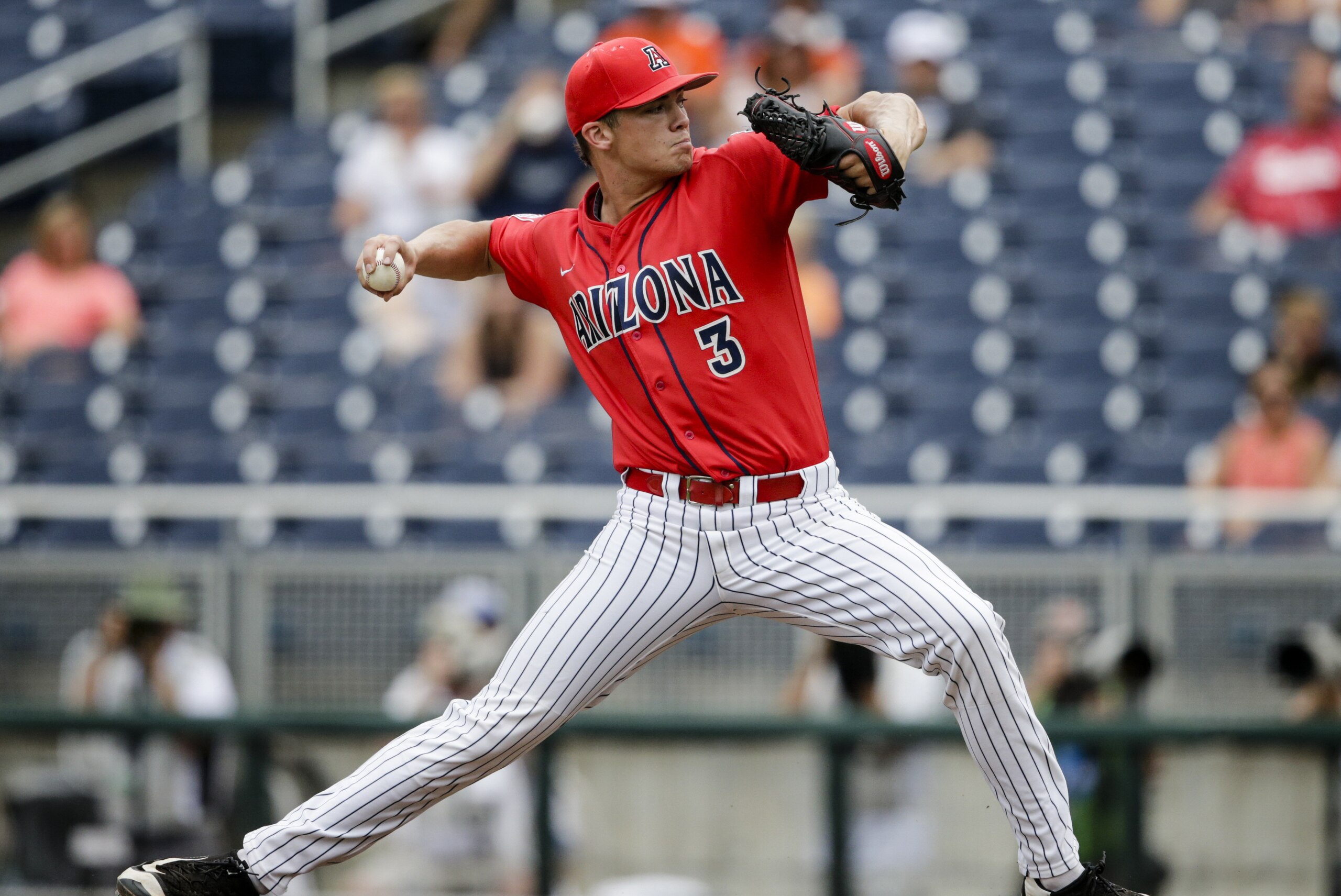 Arizona starting pitcher Bobby Dalbec (3) throws during the first inning of an NCAA men's College World Series baseball game against Oklahoma State in Omaha, Neb., Saturday, June 25, 2016. (AP Photo/Nati Harnik)
