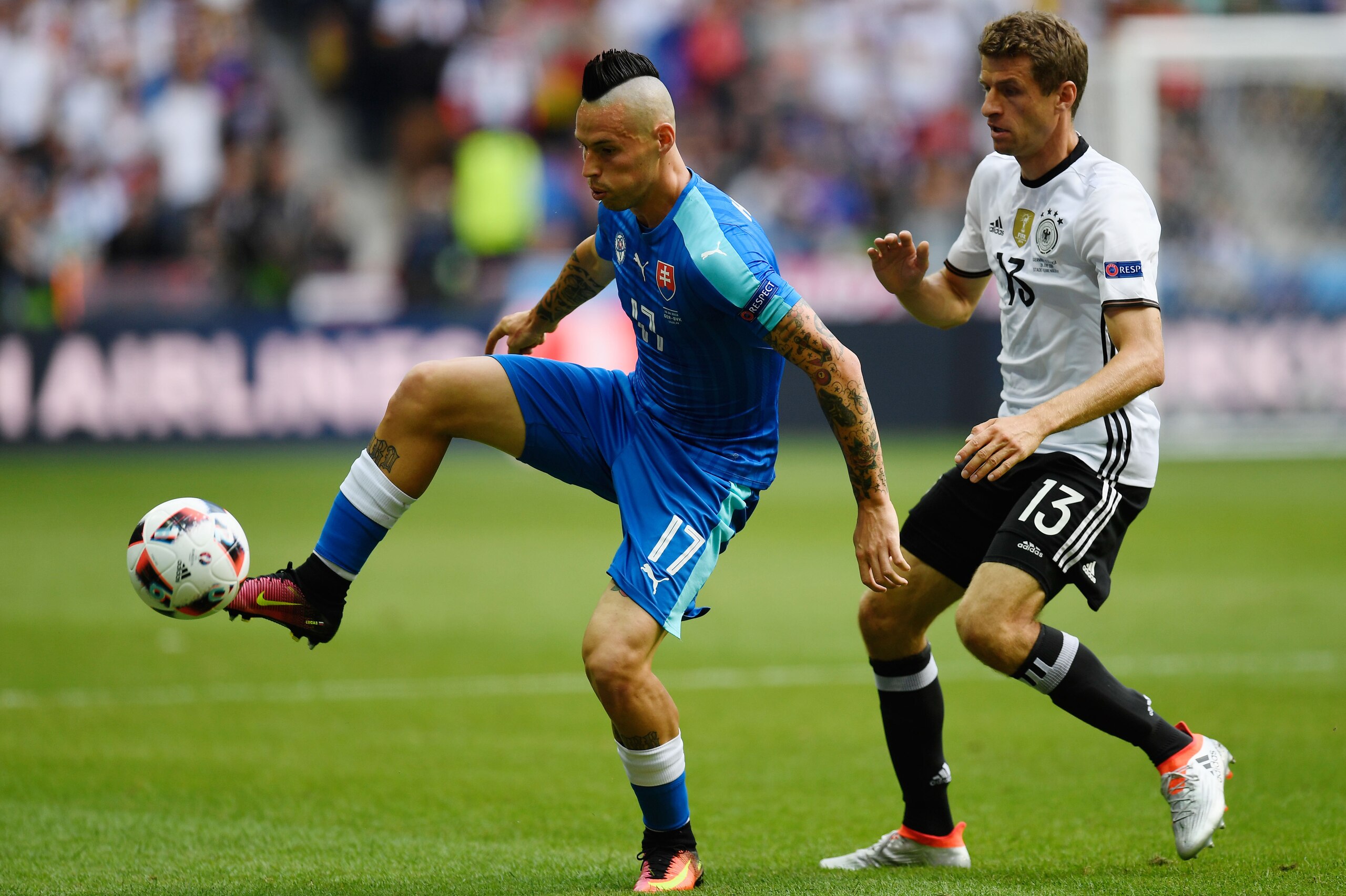 LILLE, FRANCE - JUNE 26: Marek Hamsik of Slovakia controls the ball under pressure of Thomas Mueller of Germany  during the UEFA EURO 2016 round of 16 match between Germany and Slovakia at Stade Pierre-Mauroy on June 26, 2016 in Lille, France.  (Photo by Mike Hewitt/Getty Images)