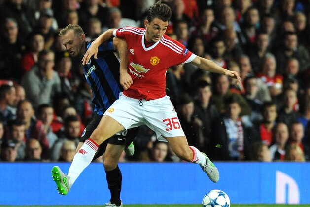 Manchester United’s Matteo Darmian, right, tussles with Brugge’s Laurens De Bock during the Champions League play-off round, first leg soccer match between Manchester United and Club Brugge at Old Trafford, Manchester, England, Tuesday, Aug. 18, 2015. (AP Photo/Rui Vieira)