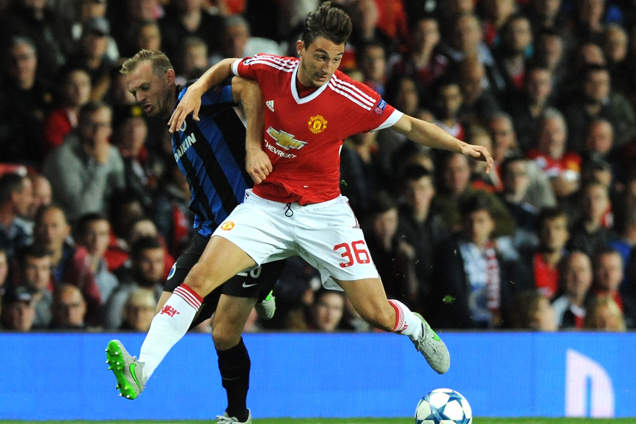 Manchester United’s Matteo Darmian, right, tussles with Brugge’s Laurens De Bock during the Champions League play-off round, first leg soccer match between Manchester United and Club Brugge at Old Trafford, Manchester, England, Tuesday, Aug. 18, 2015. (AP Photo/Rui Vieira)