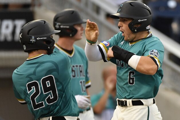 Coastal Carolina's Anthony Marks (29) and Connor Owings (6) celebrate after they scored against TCU on a two-run triple by G.K. Young during the third inning of an NCAA men's College World Series baseball game in Omaha, Neb., Saturday, June 25, 2016. (AP Photo/Ted Kirk)