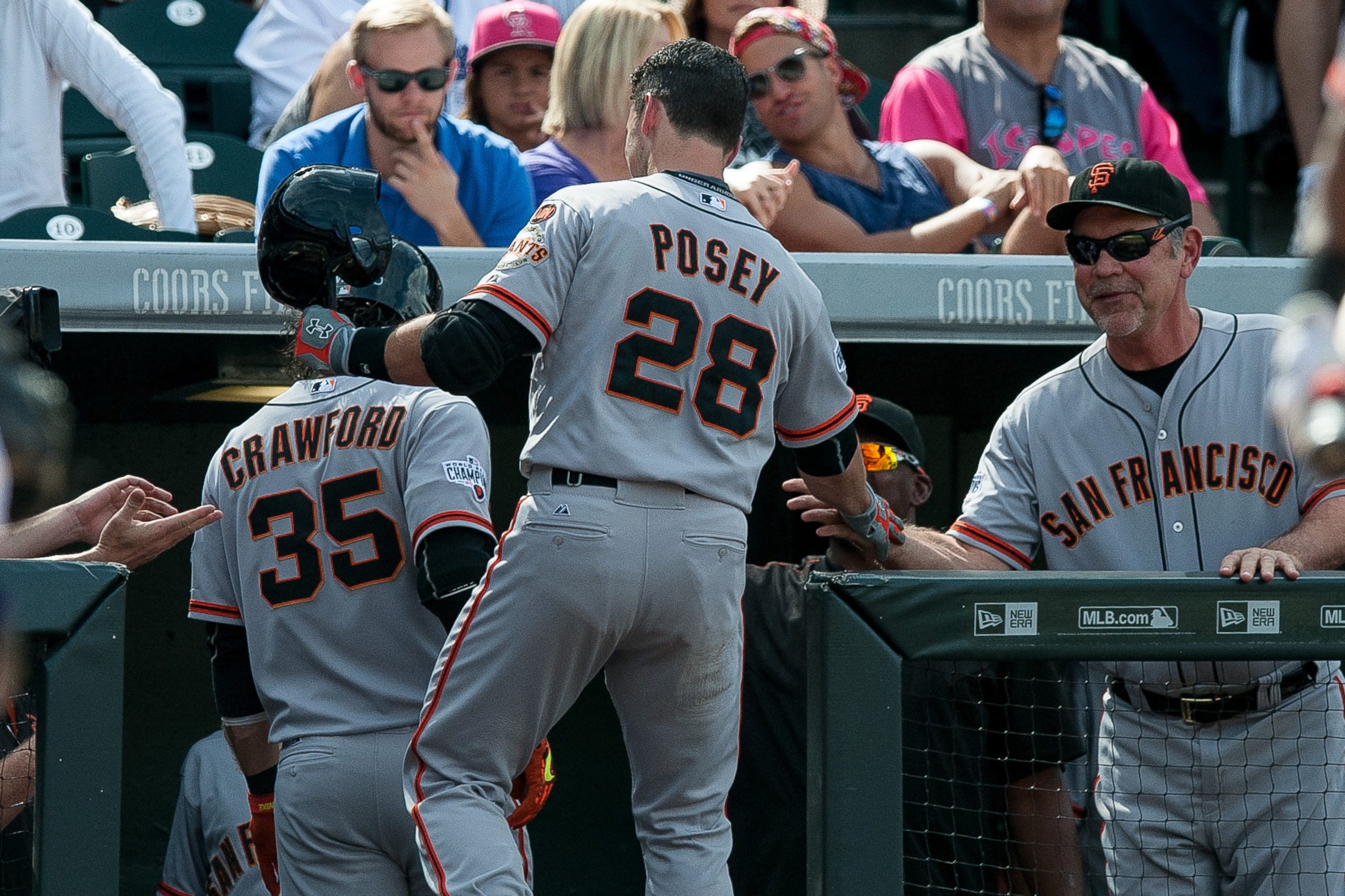 DENVER, CO - SEPTEMBER 6:   Buster Posey #28 of the San Francisco Giants celebrates with manager Bruce Bochy #15 after hitting a fourth inning solo home run for the 100th of his career against the Colorado Rockies during a game at Coors Field on September 6, 2015 in Denver, Colorado.  (Photo by Dustin Bradford/Getty Images)