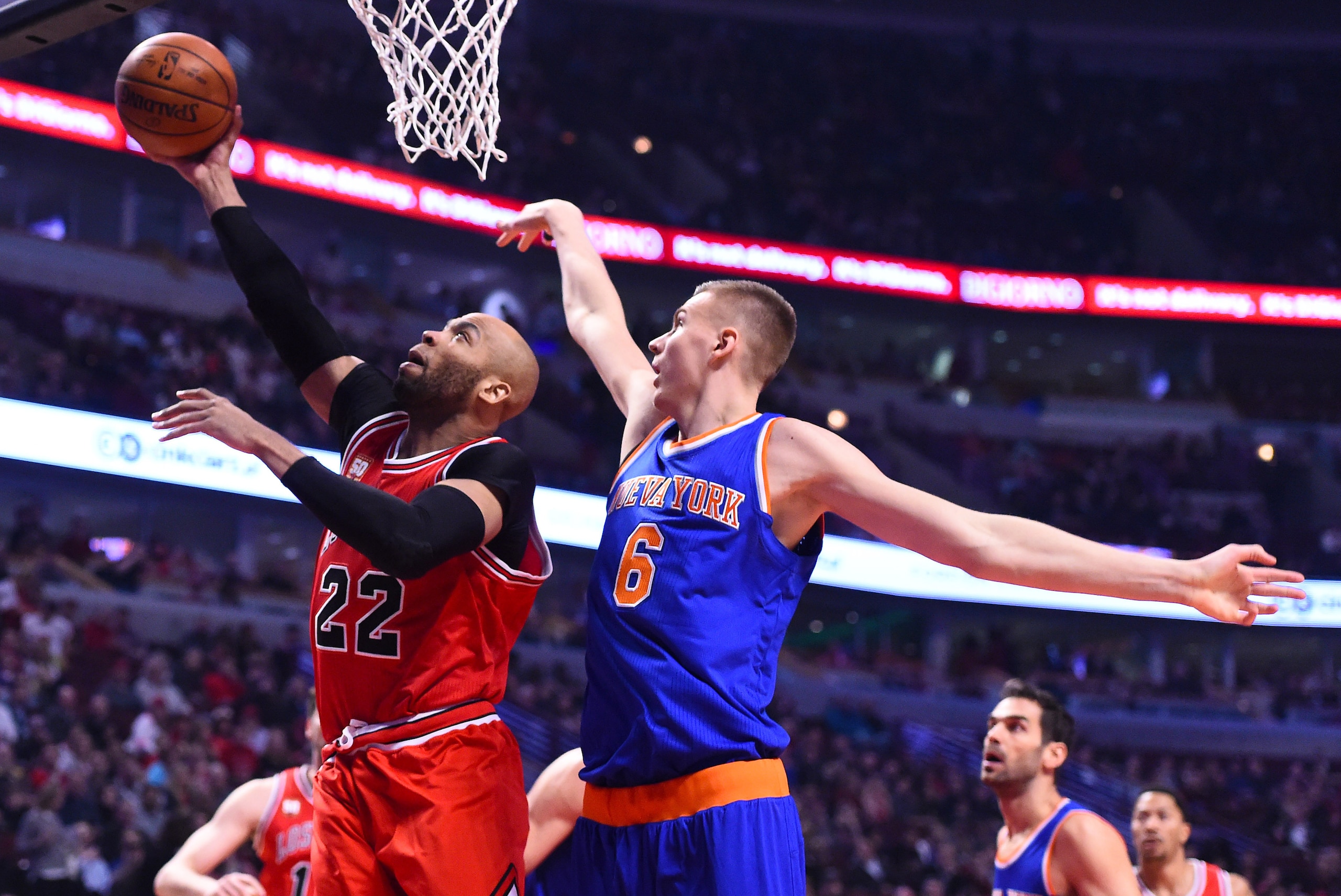 Mar 23, 2016; Chicago, IL, USA; Chicago Bulls forward Taj Gibson (22) shoots the ball as New York Knicks forward Kristaps Porzingis (6) defends during the first half at the United Center. Mandatory Credit: Mike DiNovo-USA TODAY Sports