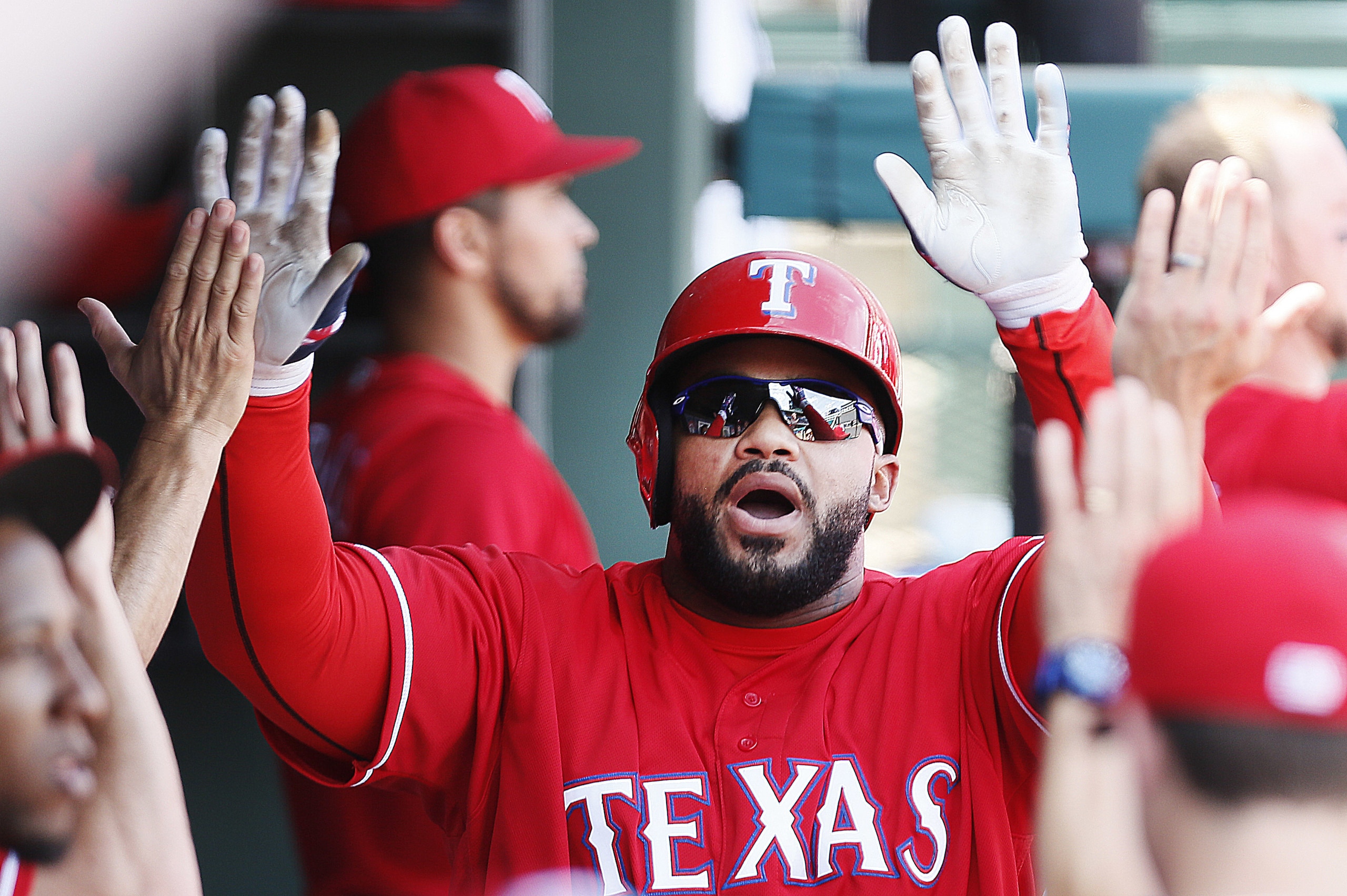 Texas Rangers designated hitter Prince Fielder is congratulated by teammates after hitting a two-run home run during the sixth inning of a baseball game against the Boston Red Sox, Sunday, June 26, 2016, in Arlington, Texas. (AP Photo/Brandon Wade)
