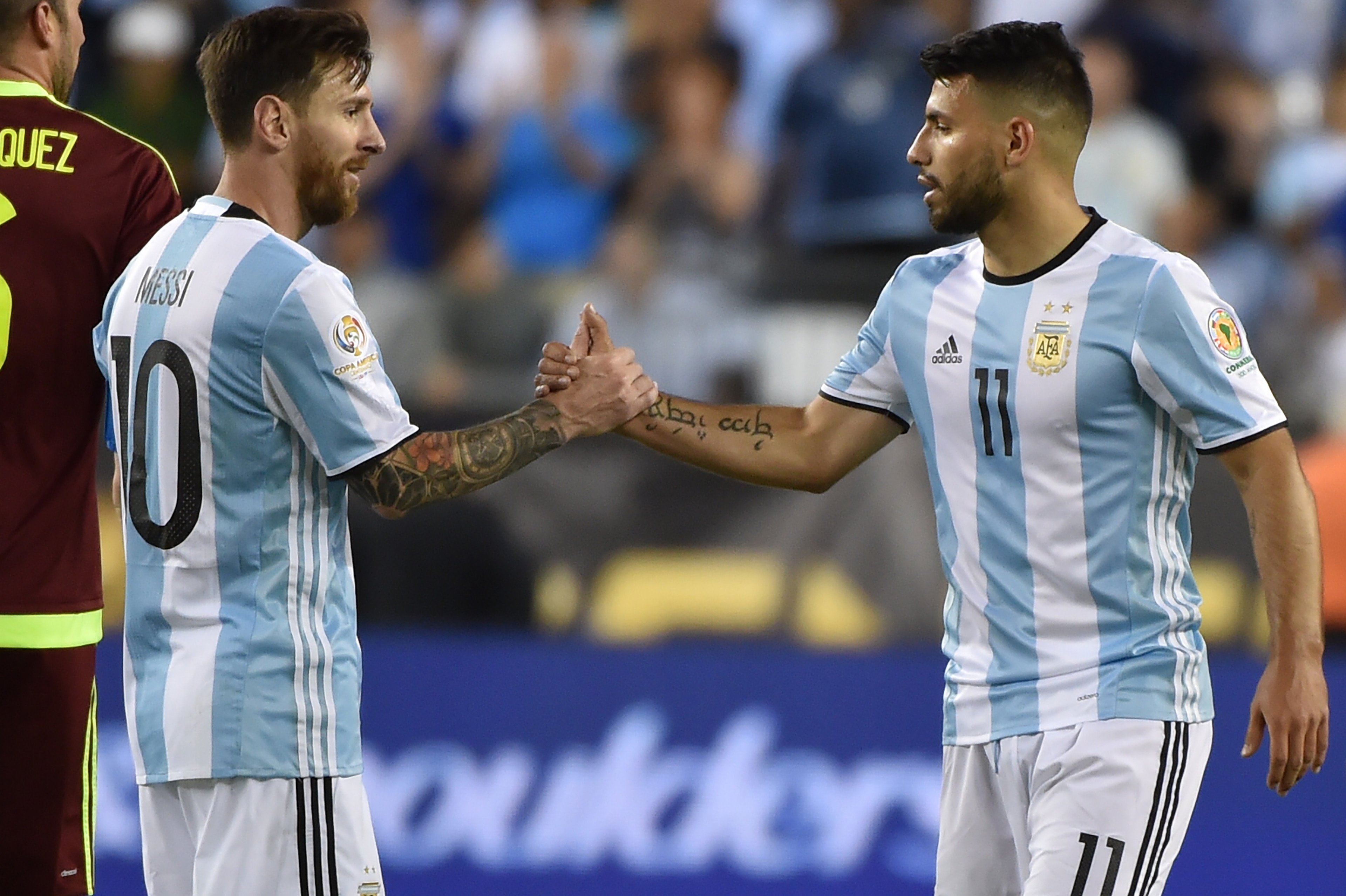 Argentina's Lionel Messi (L) greets Argentina's Sergio Aguero after their Copa America Centenario football quarterfinal match against Venezuela in Foxborough, Massachusetts, United States, on June 18, 2016.  / AFP / Nelson ALMEIDA        (Photo credit should read NELSON ALMEIDA/AFP/Getty Images)