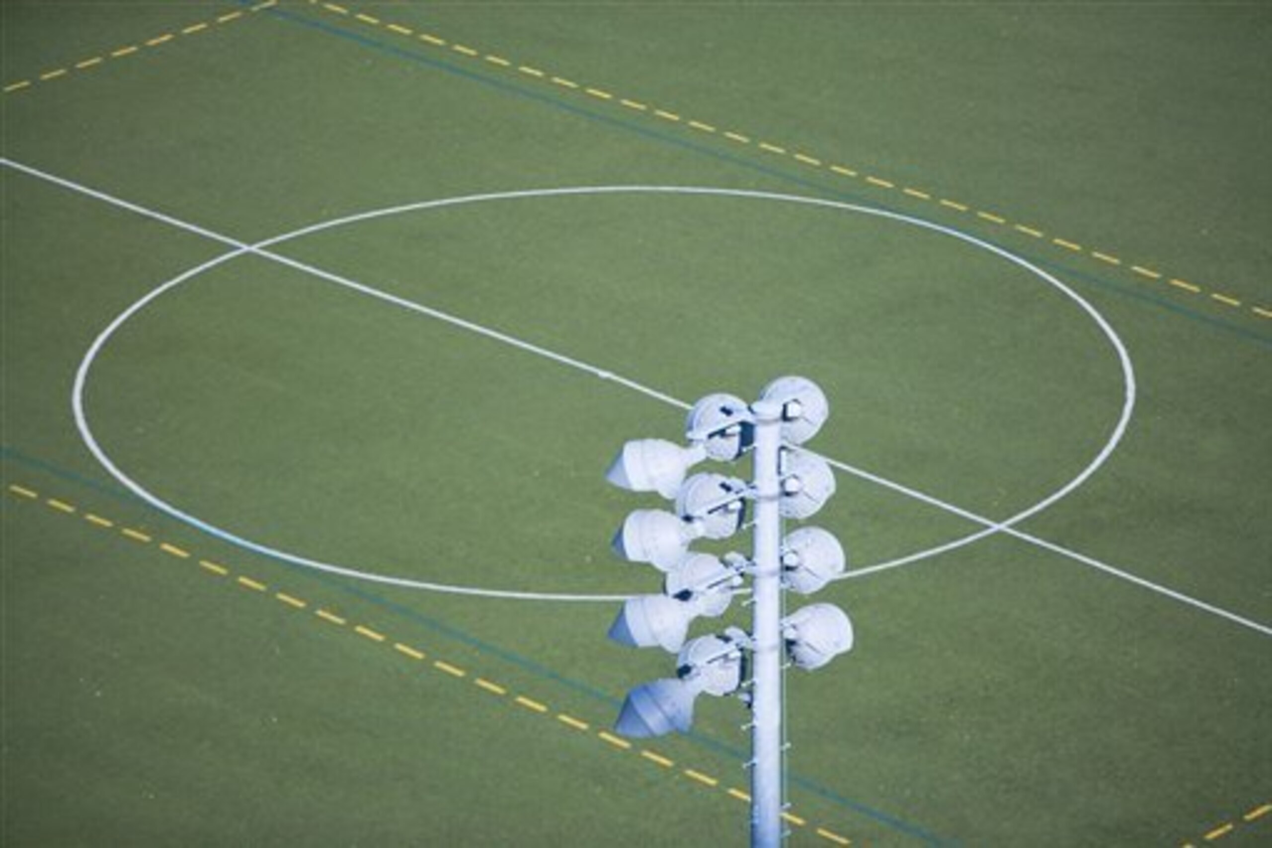 Soccer field and floodlight (Image Source via AP Images)
