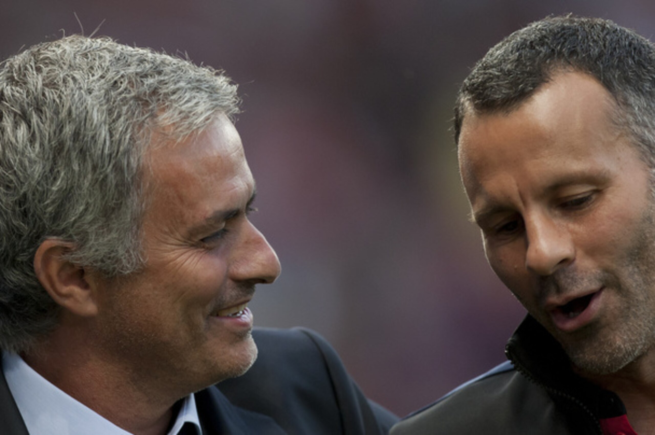 Chelsea's manager Jose Mourinho, left, speaks to Manchester United's Ryan Giggs as they make their way down the touchline before their English Premier League soccer match at Old Trafford Stadium, Manchester, England, Monday Aug. 26, 2013. (AP Photo/Jon Super) Chelsea's manager Jose Mourinho, left, speaks to Manchester United's Ryan Giggs as they make their way down the touchline before their English Premier League soccer match at Old Trafford Stadium, Manchester, England, Monday Aug. 26, 2013. (AP Photo/Jon Super)