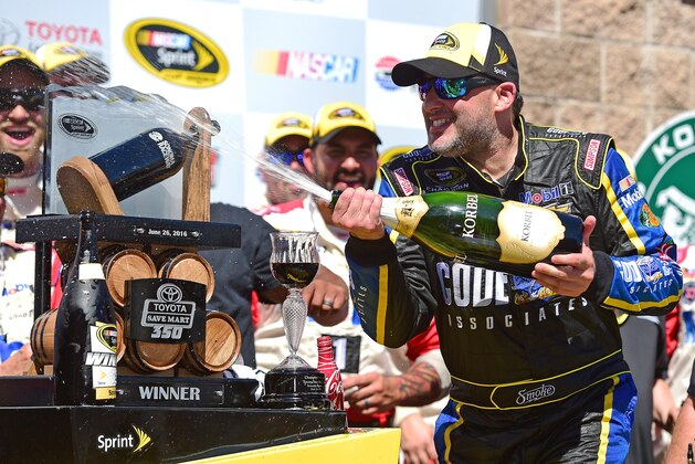 SONOMA, CA - JUNE 26:  Tony Stewart, driver of the #14 Code 3 Assoc/Mobil 1 Chevrolet, celebrates with champagne in victory lane after winning the NASCAR Sprint Cup Series Toyota/Save Mart 350 at Sonoma Raceway on June 26, 2016 in Sonoma, California.  (Photo by Jared C. Tilton/Getty Images)