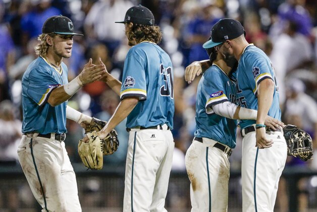 Coastal Carolina's Zach Remillard, left, Bobby Holmes (31) Michael Paez, and Mike Morrison, right, celebrate their 7-5 win over TCU in an NCAA men's College World Series baseball game in Omaha, Neb., Saturday, June 25, 2016. (AP Photo/Nati Harnik)