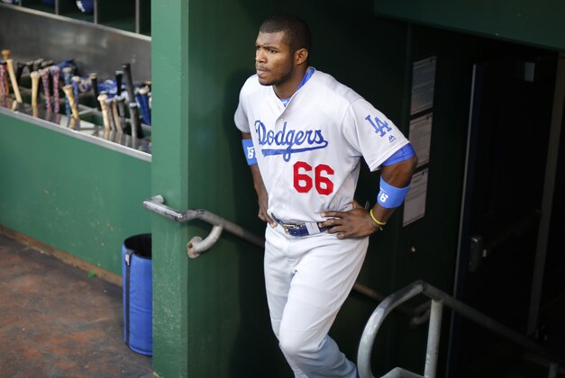 Los Angeles Dodgers right fielder Yasiel Puig walks into the dugout before a baseball game against the Pittsburgh Pirates in Pittsburgh, Friday, June 24, 2016. (AP Photo/Gene J. Puskar)