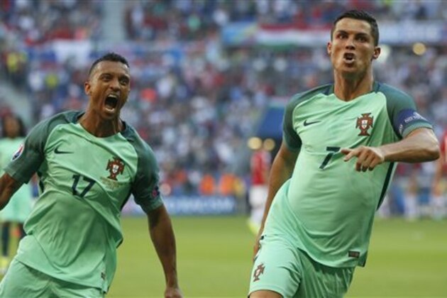 Portugal's Cristiano Ronaldo celebrates with teammate Nani, left, after scoring his side's second goal during the Euro 2016 Group F soccer match between Hungary and Portugal at the Grand Stade in Decines-­Charpieu, near Lyon, France, Wednesday, June 22, 2016. (AP Photo/Darko Bandic)