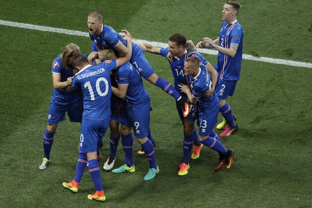 Iceland players celebrate after their teammate Ragnar Sigurdsson scored during the Euro 2016 round of 16 soccer match between England and Iceland, at the Allianz Riviera stadium in Nice, France, Monday, June 27, 2016. (AP Photo/Ariel Schalit)