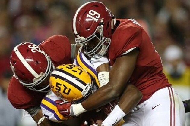 FILE - In this Nov. 7, 2015, file photo, LSU quarterback Brandon Harris (6) is hit by Alabama linebacker Reggie Ragland (19) and Alabama defensive back Marlon Humphrey (26) in the first half of an NCAA college football game, in Tuscaloosa , Ala. Miles acknowledged this week that his offensive line has hit a