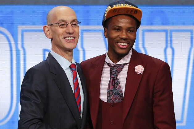Malik Beasley, right, poses for a photo with NBA Commissioner Adam Silver after being selected 19th overall by the Denver Nuggets during the NBA basketball draft, Thursday, June 23, 2016, in New York. (AP Photo/Frank Franklin II)