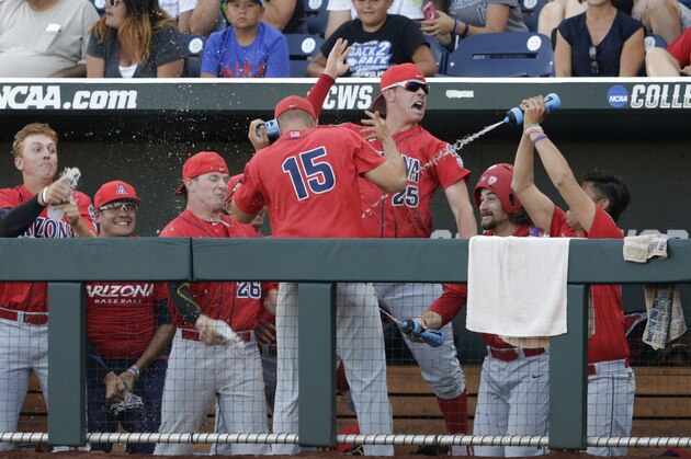 Arizona's Cody Deason (15) and Austin Rubick (25) have fun in the dugout before the fourth inning against Coastal Carolina in Game 1 of the NCAA Men's College World Series finals baseball game in Omaha, Neb., Monday, June 27, 2016. (AP Photo/Nati Harnik)