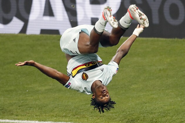 Belgium's Michy Batshuayi performs a somersault as he celebrates his side's second goal during the Euro 2016 round of 16 soccer match between Hungary and Belgium, at the Stadium municipal in Toulouse, France, Sunday, June 26, 2016. (AP Photo/Francois Mori)