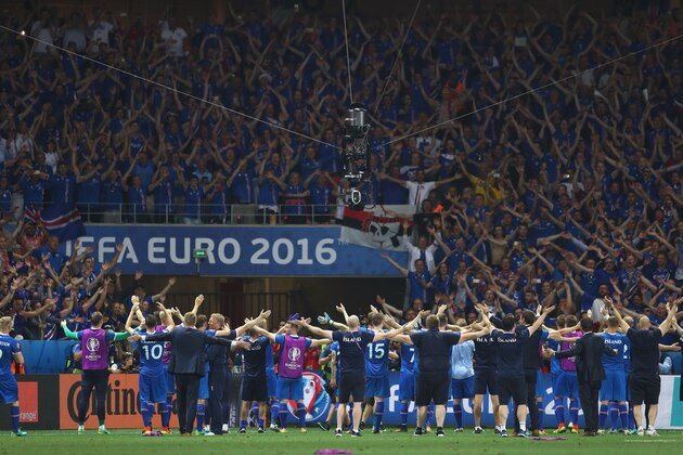 NICE, FRANCE - JUNE 27:  Iceland players celebrate their team's 2-1 win in front of the supporters after the UEFA EURO 2016 round of 16 match between England and Iceland at Allianz Riviera Stadium on June 27, 2016 in Nice, France.  (Photo by Lars Baron/Getty Images)
