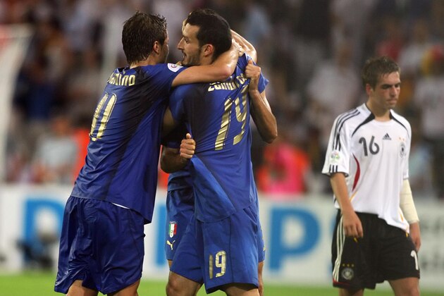 Dortmund, GERMANY:  Italian forward Alberto Gilardino (L) celebrate with Italian defender Gianluca Zambrotta (2ndL) next to German defender Philipp Lahm (R) at the end of the World Cup 2006 semi final football game Germany vs. Italy, 04 July 2006 at Dortmund stadium. Italy won 2 to 0 after extra-time.  AFP PHOTO / PATRIK STOLLARZ  (Photo credit should read PATRIK STOLLARZ/AFP/Getty Images)