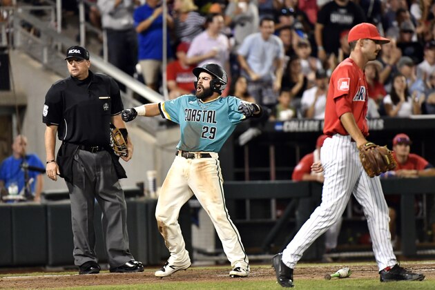 Coastal Carolina's Anthony Marks celebrates after scoring on a Connor Owings single as Arizona pitcher Cameron Ming (47) walks back to the mound in the eighth inning in Game 2 of the NCAA Men's College World Series finals baseball game in Omaha, Neb., Tuesday, June 28, 2016. (AP Photo/Ted Kirk)