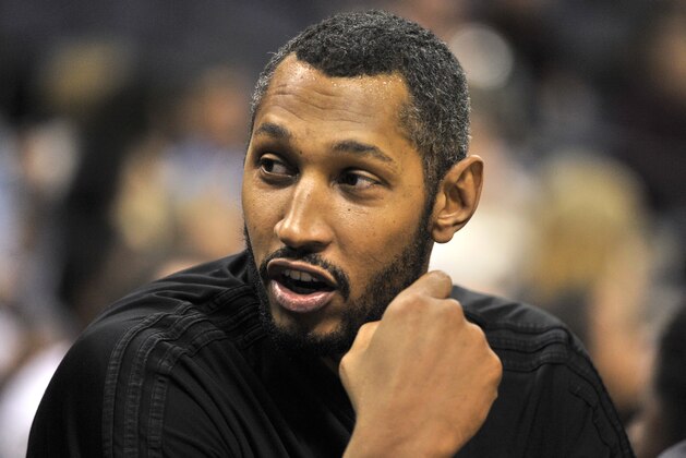 San Antonio Spurs center Boris Diaw talks with teammates on the bench in the first half of an NBA basketball game Monday, March 28, 2016, in Memphis, Tenn. (AP Photo/Brandon Dill)