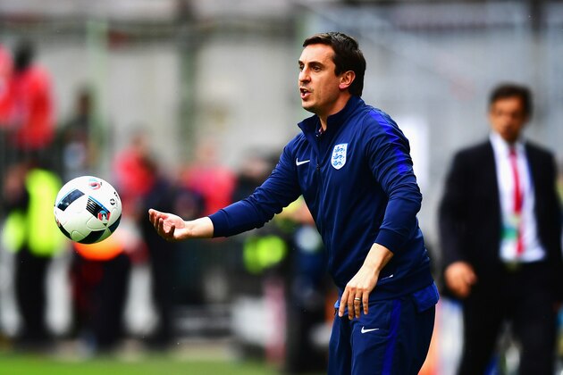 LENS, FRANCE - JUNE 16: Gary Neville coach of England picks up the ball during the UEFA EURO 2016 Group B match between England and Wales at Stade Bollaert-Delelis on June 16, 2016 in Lens, France.  (Photo by Dan Mullan/Getty Images)