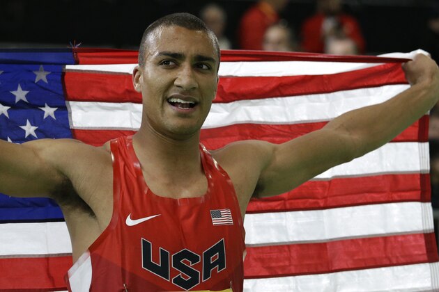 United States' Ashton Eaton holds the flag after he won the heptathlon during the World Indoor Athletics Championships, Saturday, March 19, 2016, in Portland, Ore. (AP Photo/Elaine Thompson)