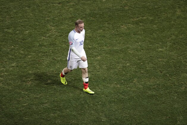 England's Wayne Rooney leave the field of play at the end of the Euro 2016 round of 16 soccer match between England and Iceland, at the Allianz Riviera stadium in Nice, France, Monday, June 27, 2016. Iceland won 2-1. (AP Photo/Ariel Schalit)