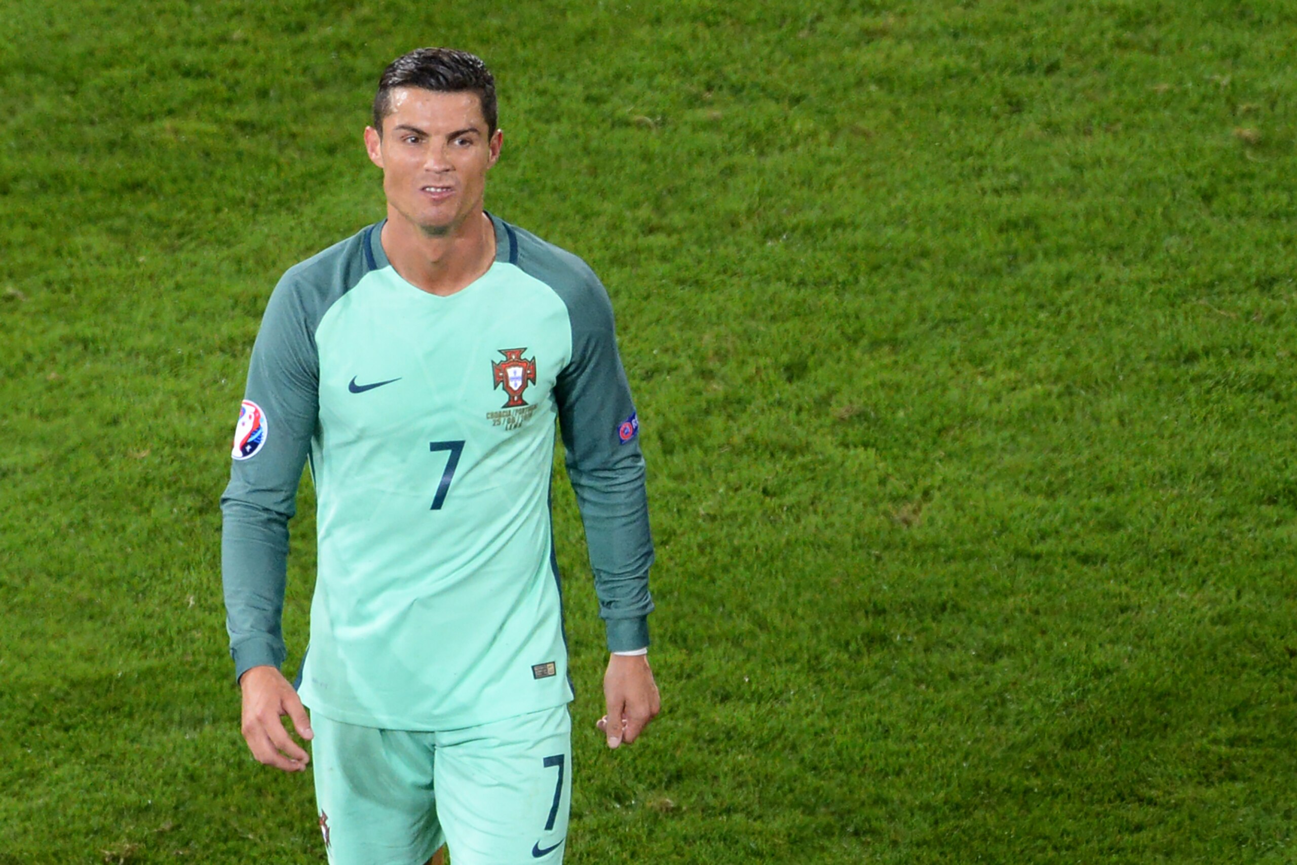 Portugal's forward Cristiano Ronaldo (C) grimaces the end of the Euro 2016 round of sixteen football match Croatia vs Portugal, on June 25, 2016 at the Bollaert-Delelis stadium in Lens. / AFP / FRANCOIS LO PRESTI        (Photo credit should read FRANCOIS LO PRESTI/AFP/Getty Images)